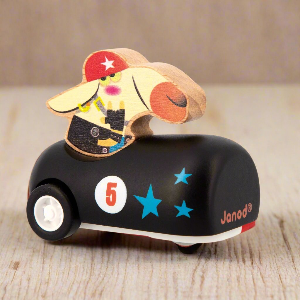 Dog sitting in a black Wooden Pull-Back Car by Janod