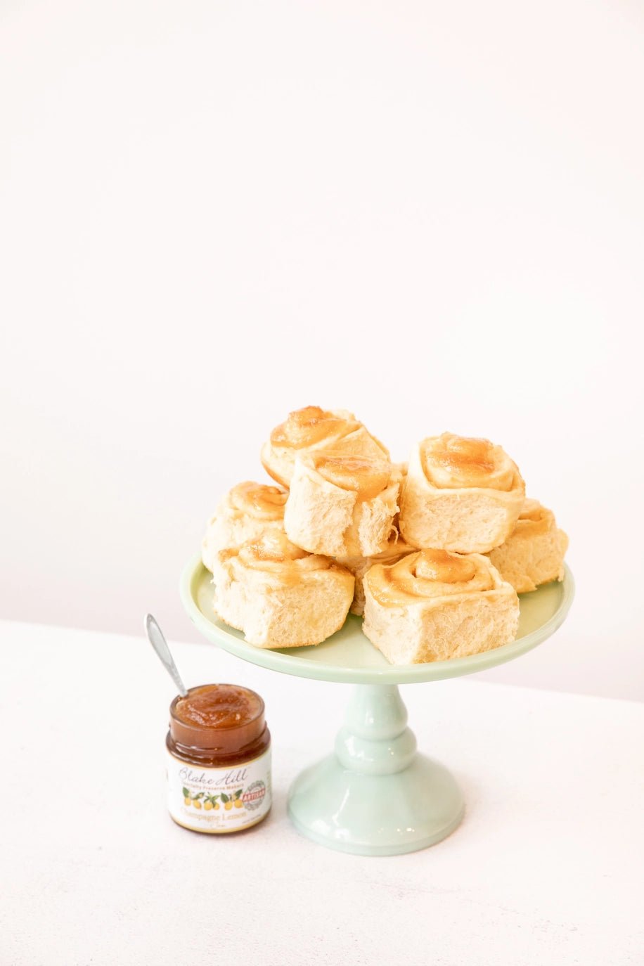 Pastries topped with Lemon Champagne Jam by Blake Hill Preserves on a green cake stand