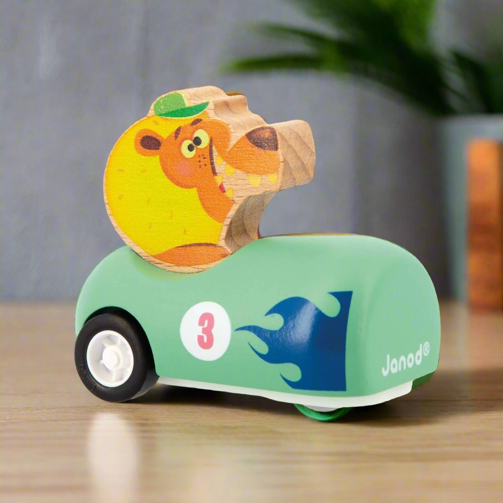 Lion sitting in a green Wooden Pull-Back Car by Janod