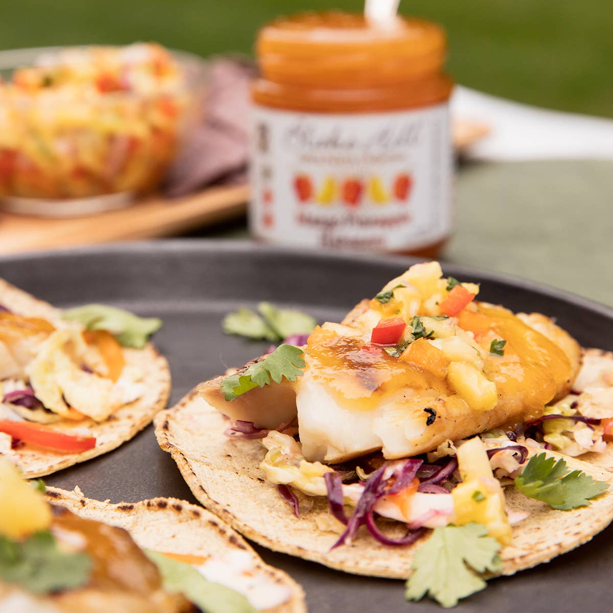 Fish tacos drizzled with salsa made from Mango Habanero Chili Jam by Blake Hill Preserves – an award-winning preserve