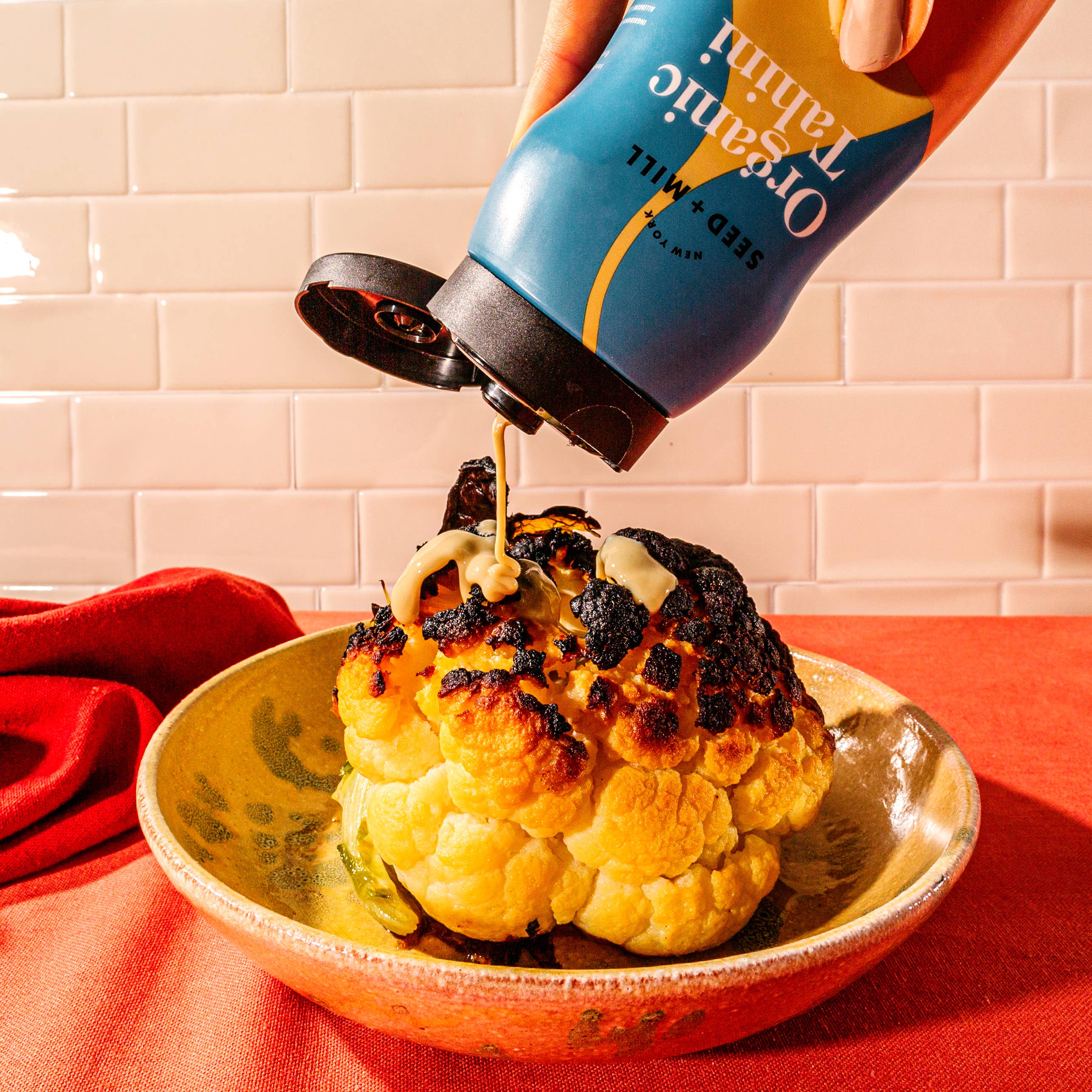 Roasted cauliflower drizzled with Organic Tahini Squeeze Bottle by Seed + Mill – vegan, gluten-free