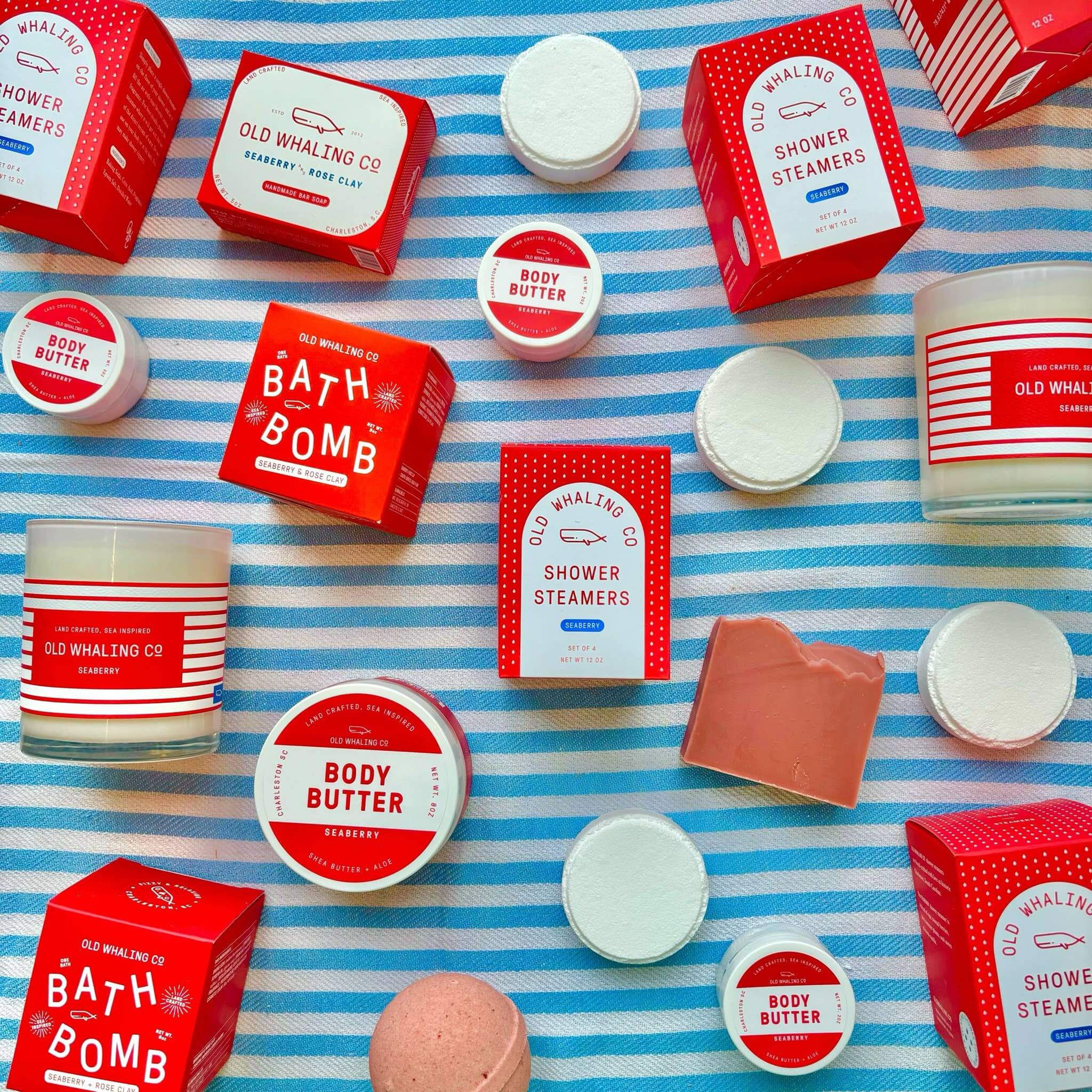 upclose version of seaberry shower steamers by Old Whaling Co laid out on a blue white stripe towel surrounded by other Seaberry products