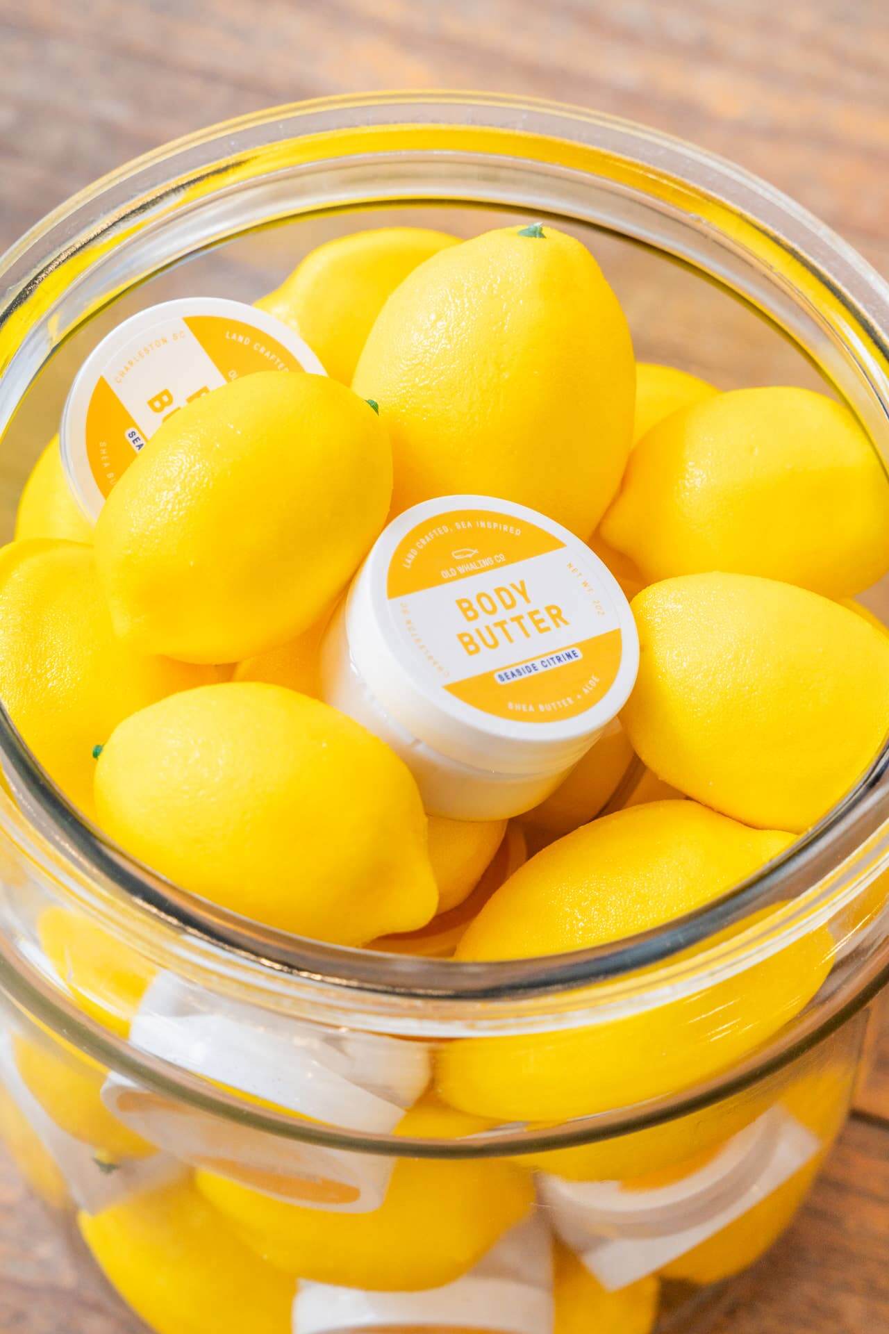 Close-up of Seaside Citrine 2oz travel size body butter by Old Whaling Co in a plastic jar