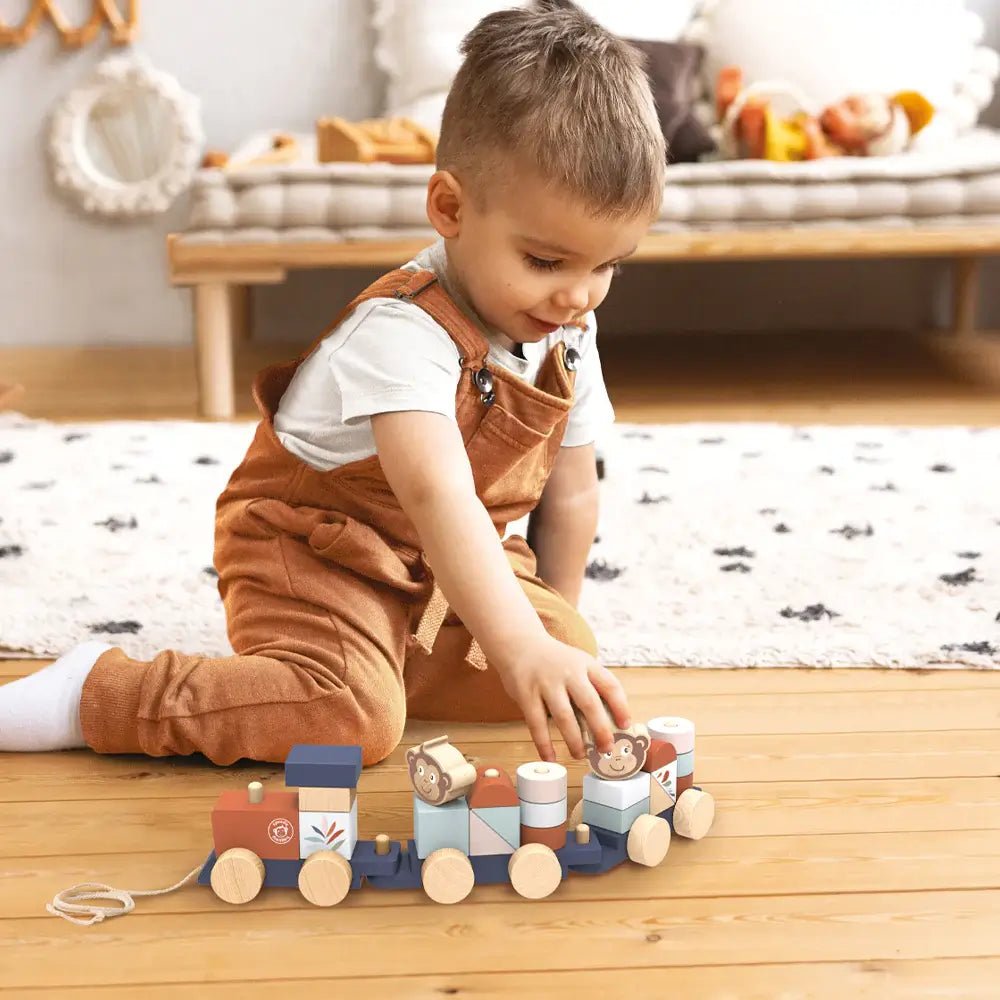 A child playing with the Stacking Train by Speedy Monkey – a wooden stacking train toy.