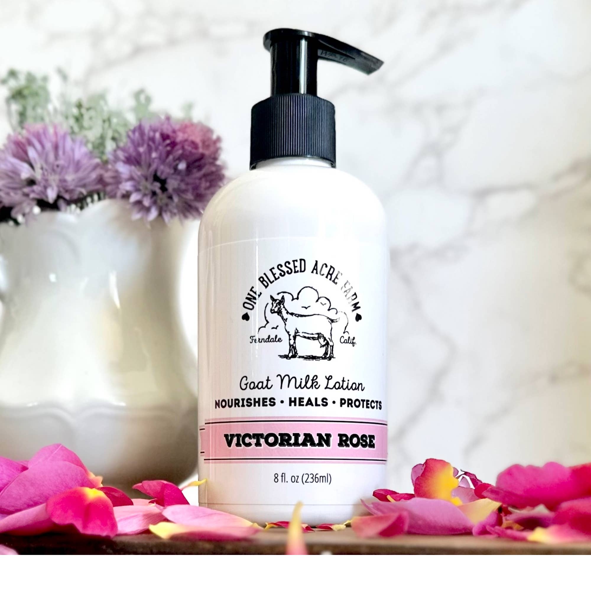 8oz Victorian Rose Goat Milk Lotion by One Blessed Acre with flowers and petals in the background