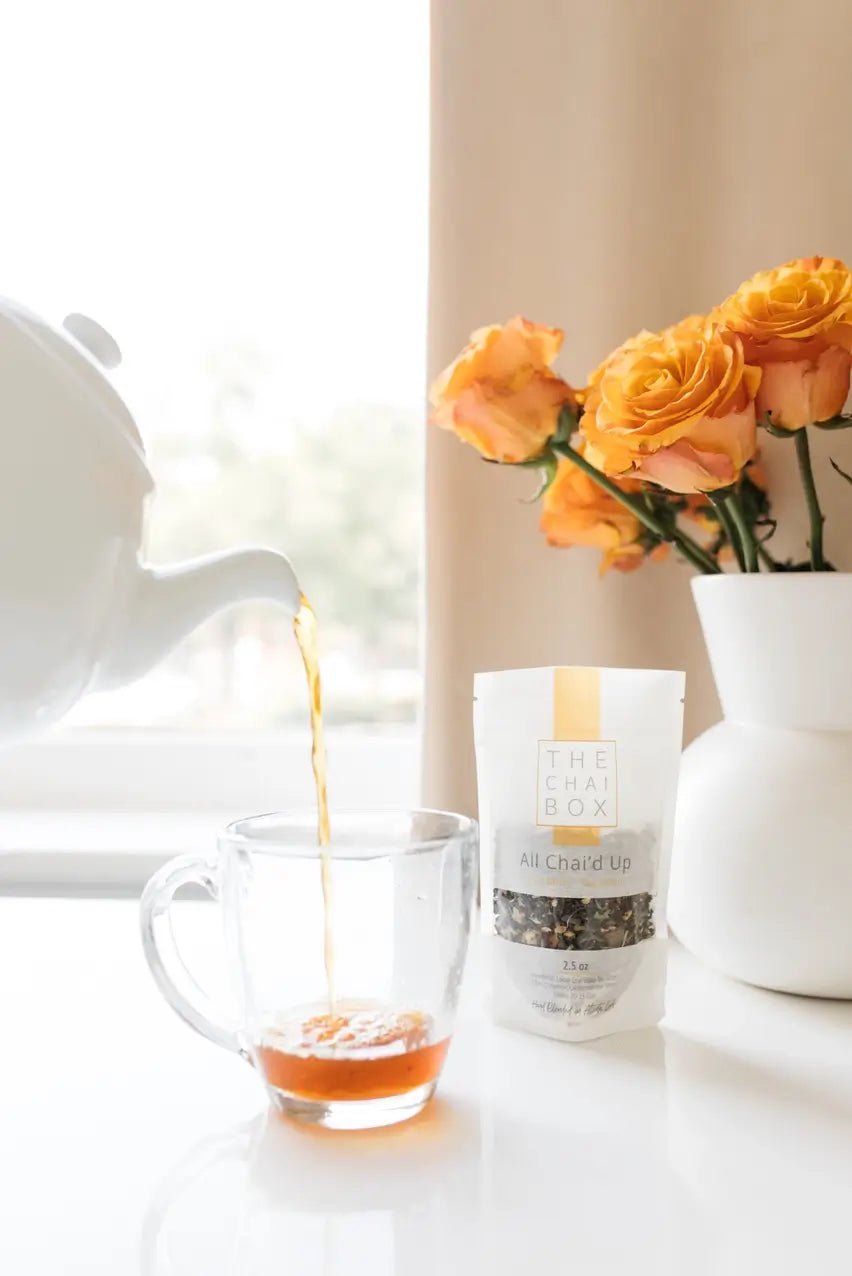 The Chai Box All Chaid Up being poured into a glass mug.