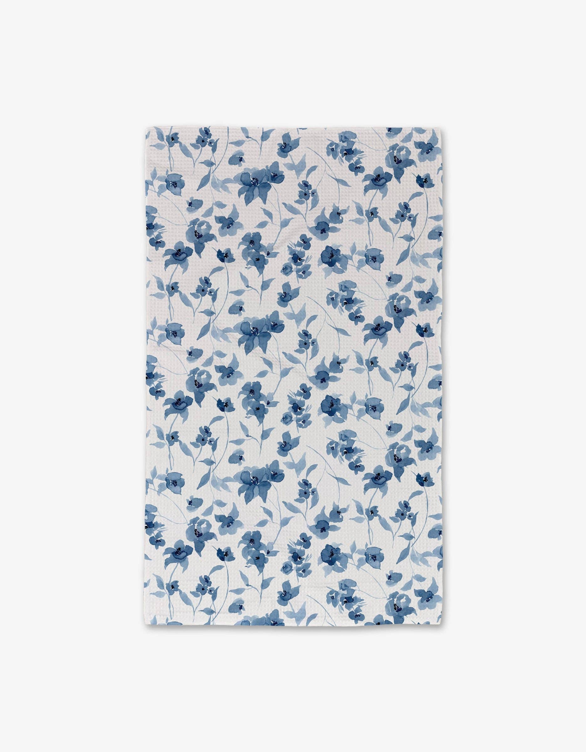 Blue Floral Luxe Hand Towel by Geometry. Towel has a blue floral print on a white background.