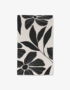 Harmony Luxe Hand Towel by Geometry. Hand Towel has black flowers and leaves on a white background.
