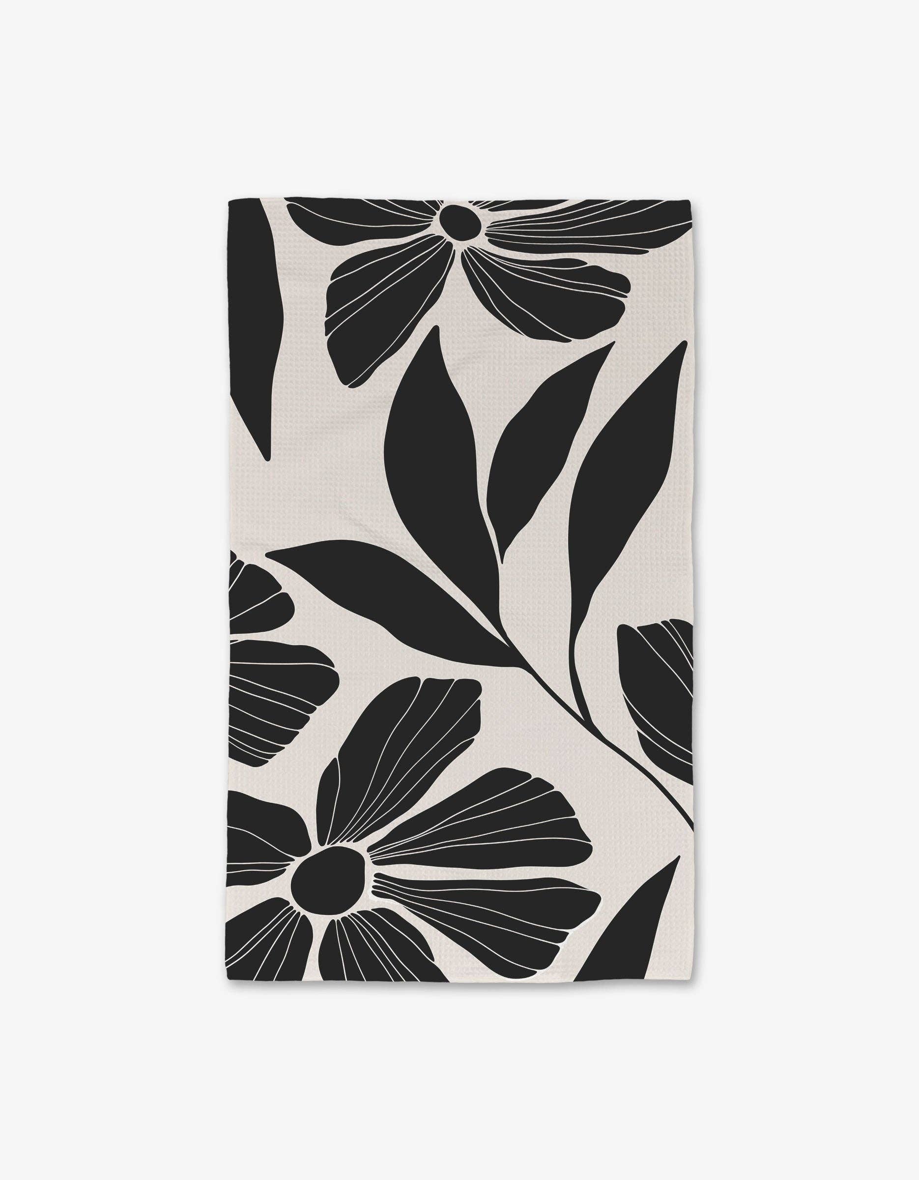 Harmony Luxe Hand Towel by Geometry. Hand Towel has black flowers and leaves on a white background.