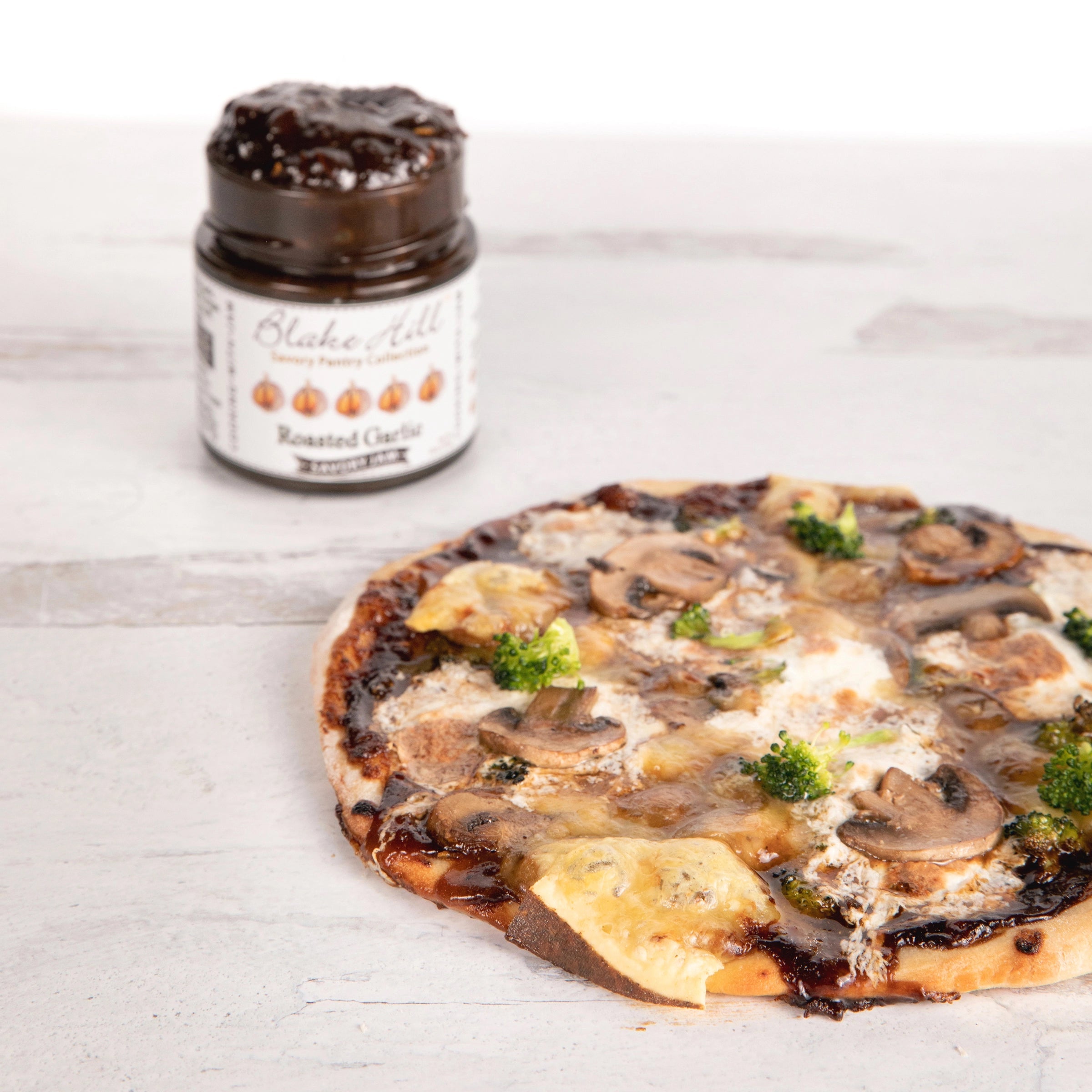 Pizza topped with Blake Hill Preserves Blake Hills Preserves Roasted Garlic Savory jam.