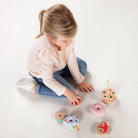 Kid playing with Alice Stacking Pyramid