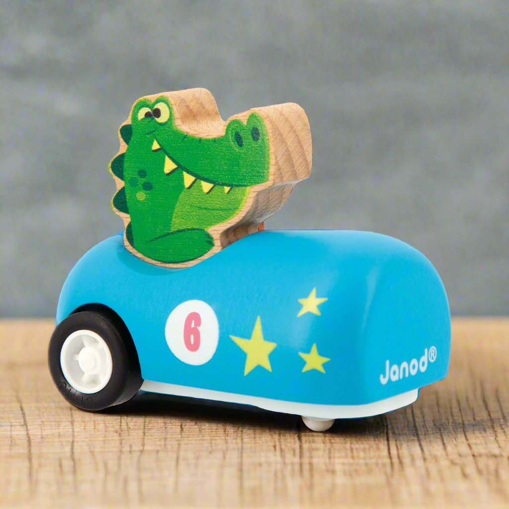 Alligator sitting in a light blue Wooden Pull-Back Car