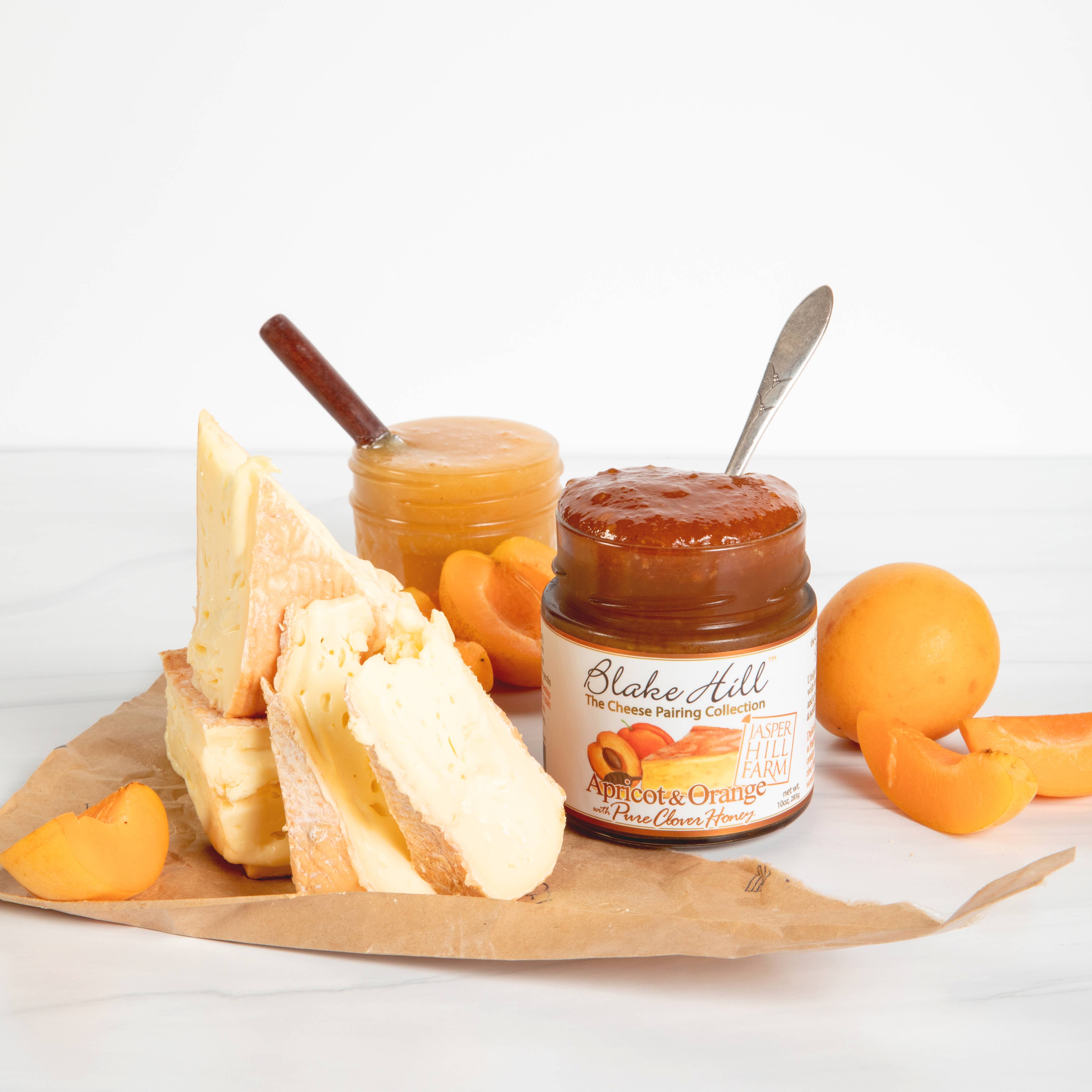 Blake Hill Preserves Apricot Orange & Honey Jam surrounded by cheese and apricots