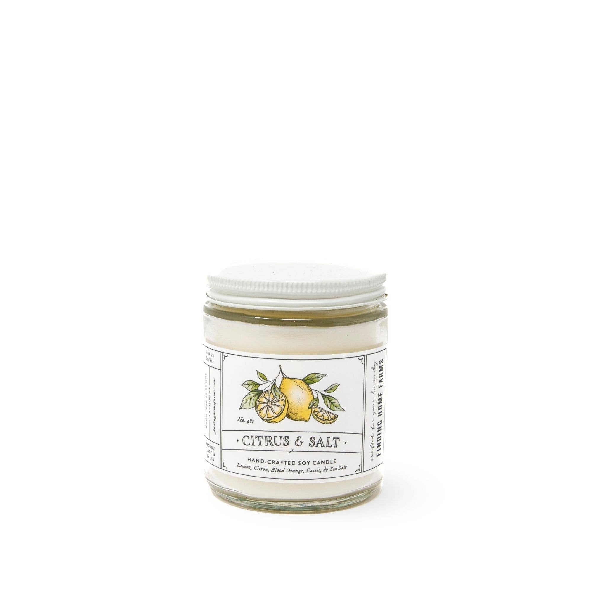 A Citrus & Salt Soy Candle in a clear glass jar by Finding Home Farms