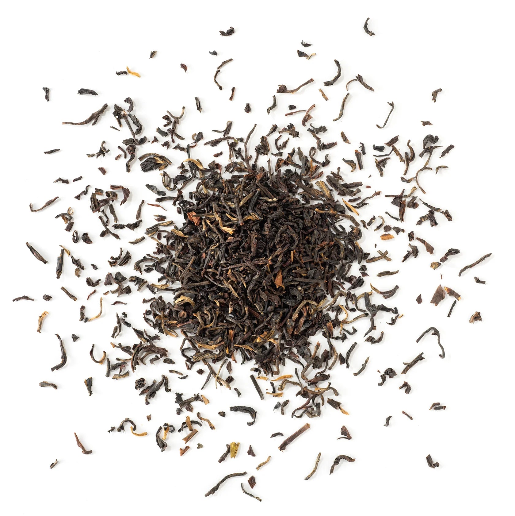 Loose dry black tea leaves from Apolis Tea's English Breakfast blend, artfully scattered against a clean white background.