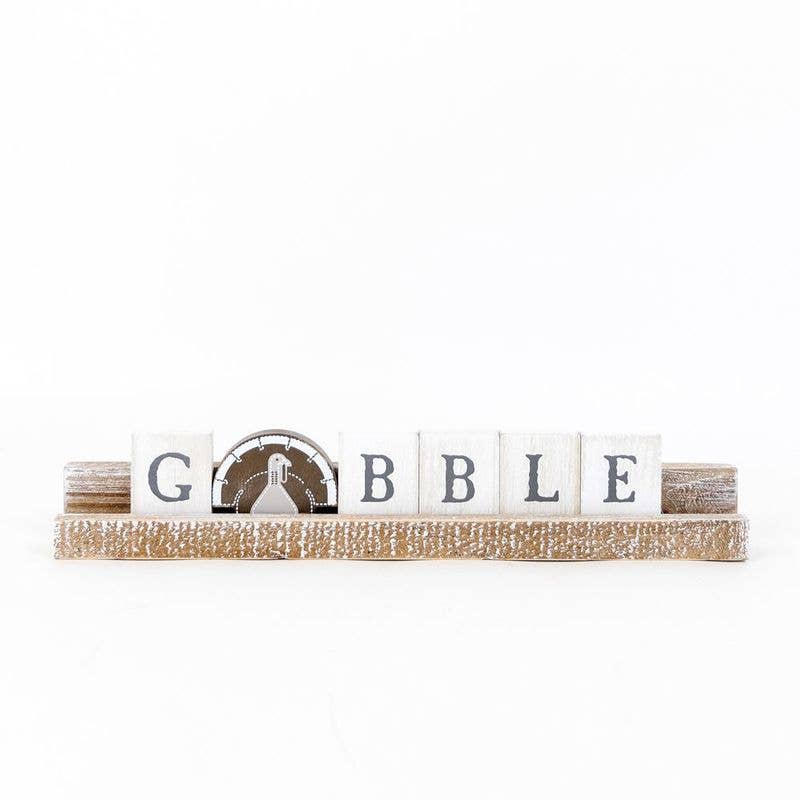 Decorative sign with 'Gobble' on a white background