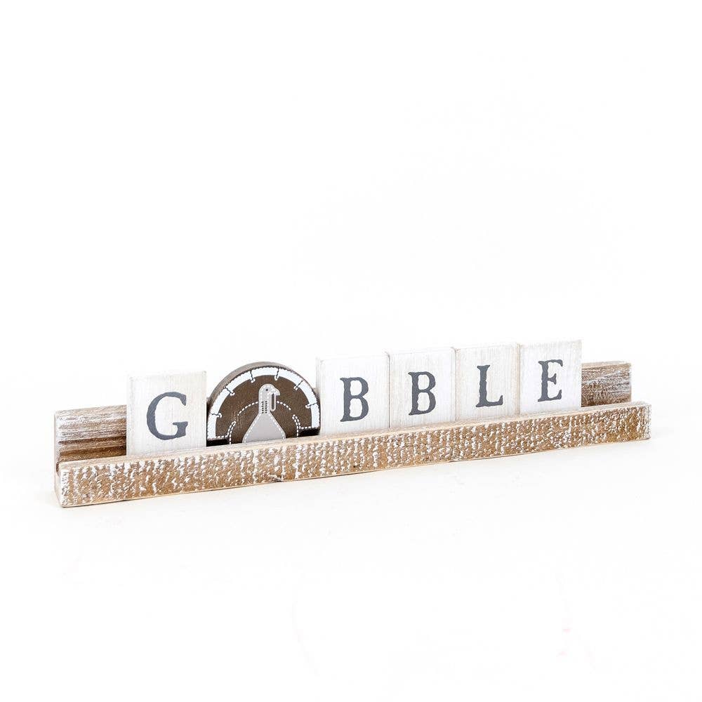 Another view ot the decorative sign with 'Gobble' letters on a white background