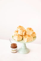 Pastries topped with Lemon Champagne Jam by Blake Hill Preserves on a green cake stand