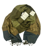 The Mossy Hillside Woven Scarf by Fair Anita features a green and brown pattern inspired by nature’s earthy tones.