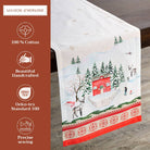 Rural Christmas Table Runner by Maison d'Hermine, showcasing a festive winter scene design on a wooden surface, complete with branding and product details.