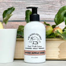 8 oz bottle of spiced apple cider goat milk lotion by One Blessed Acre Farm with a rustic background