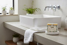 Kind Apothecary Tea Tree Mint RX shower and shampoo bar being used in a bathroom setting 