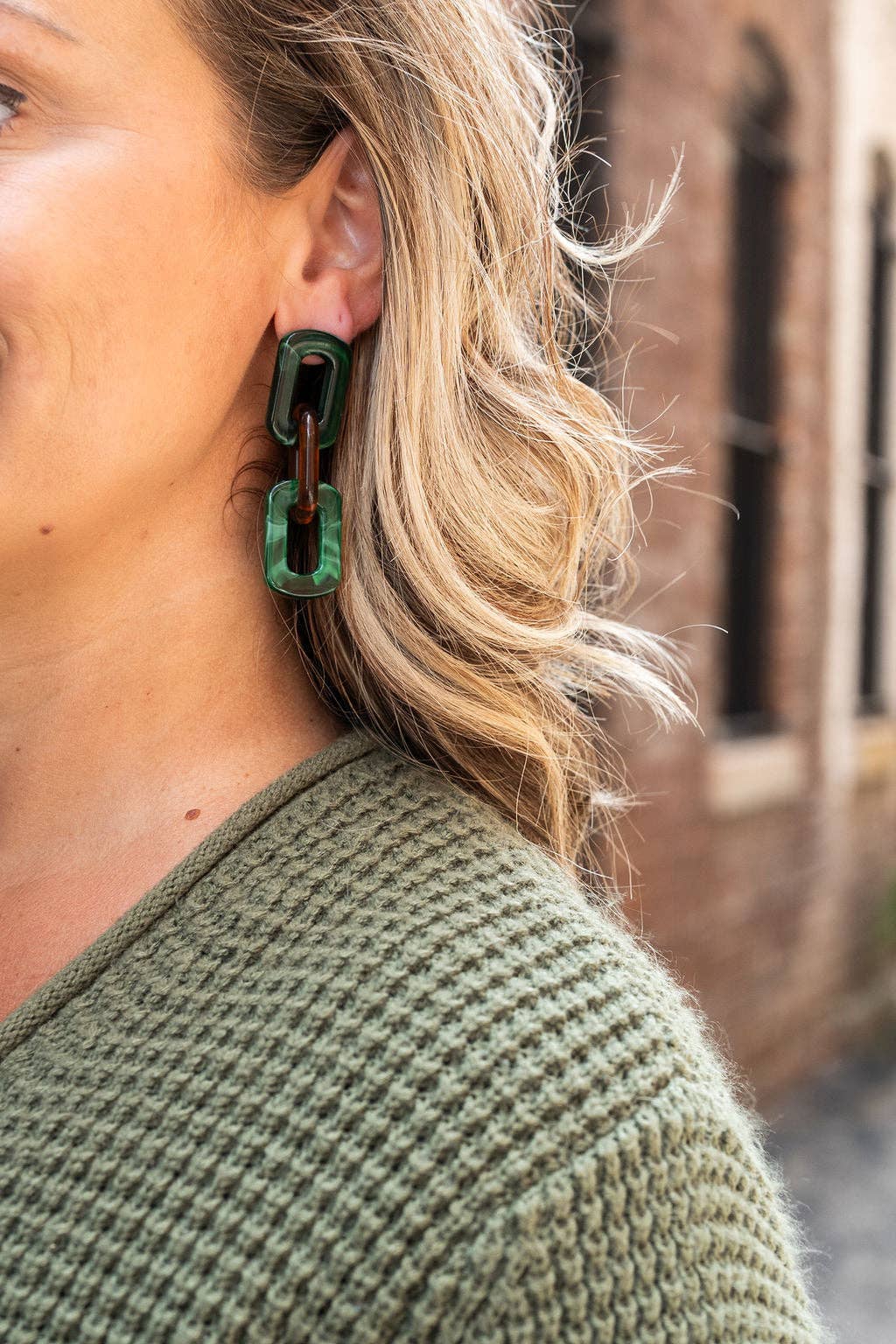 A person wearing Forest Green and Amber Tabitha Earrings by Spiffy and Splendid.