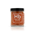 Spiceology Smoky Honey Habanero in a glass jar.