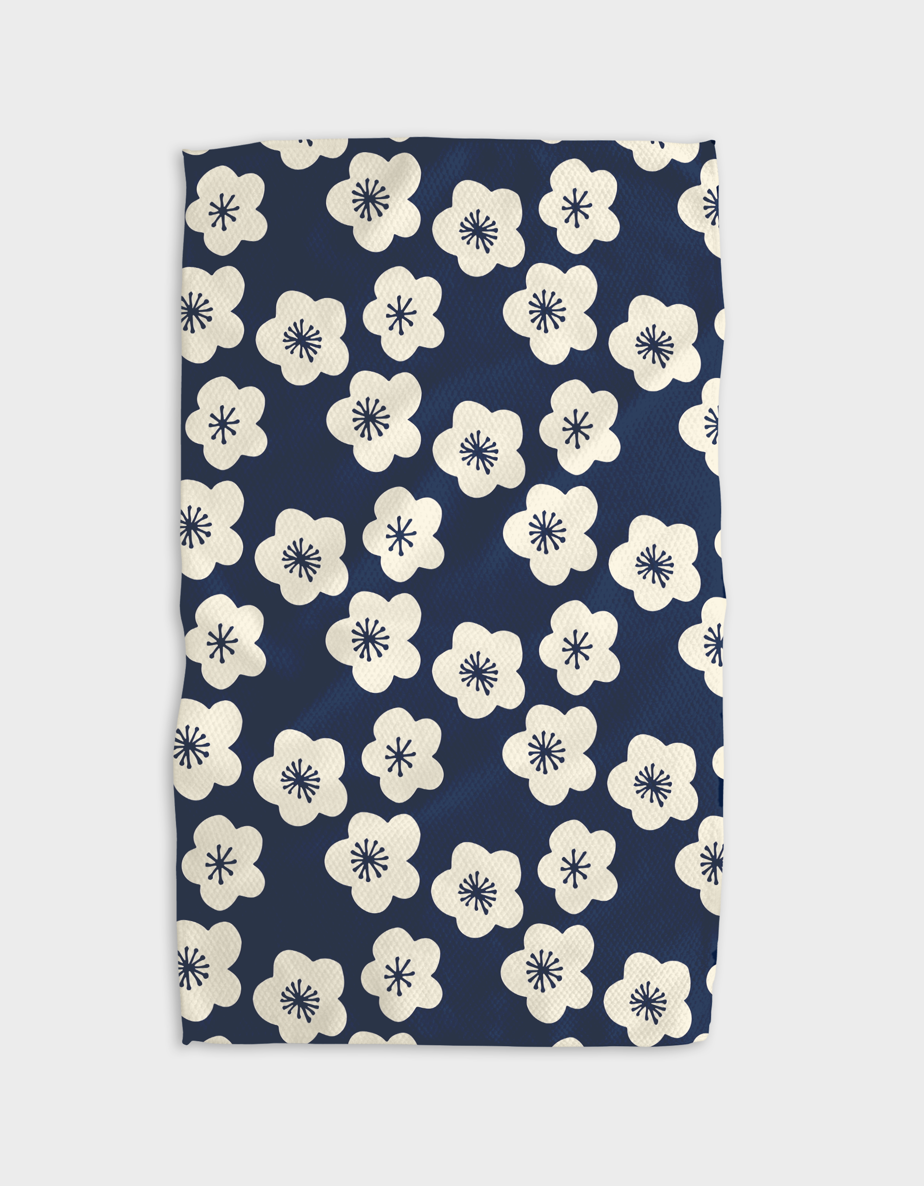 Every Sunday Kitchen Tea Towel by Geometry. Tea Towel has white flowers on a navy blue background.